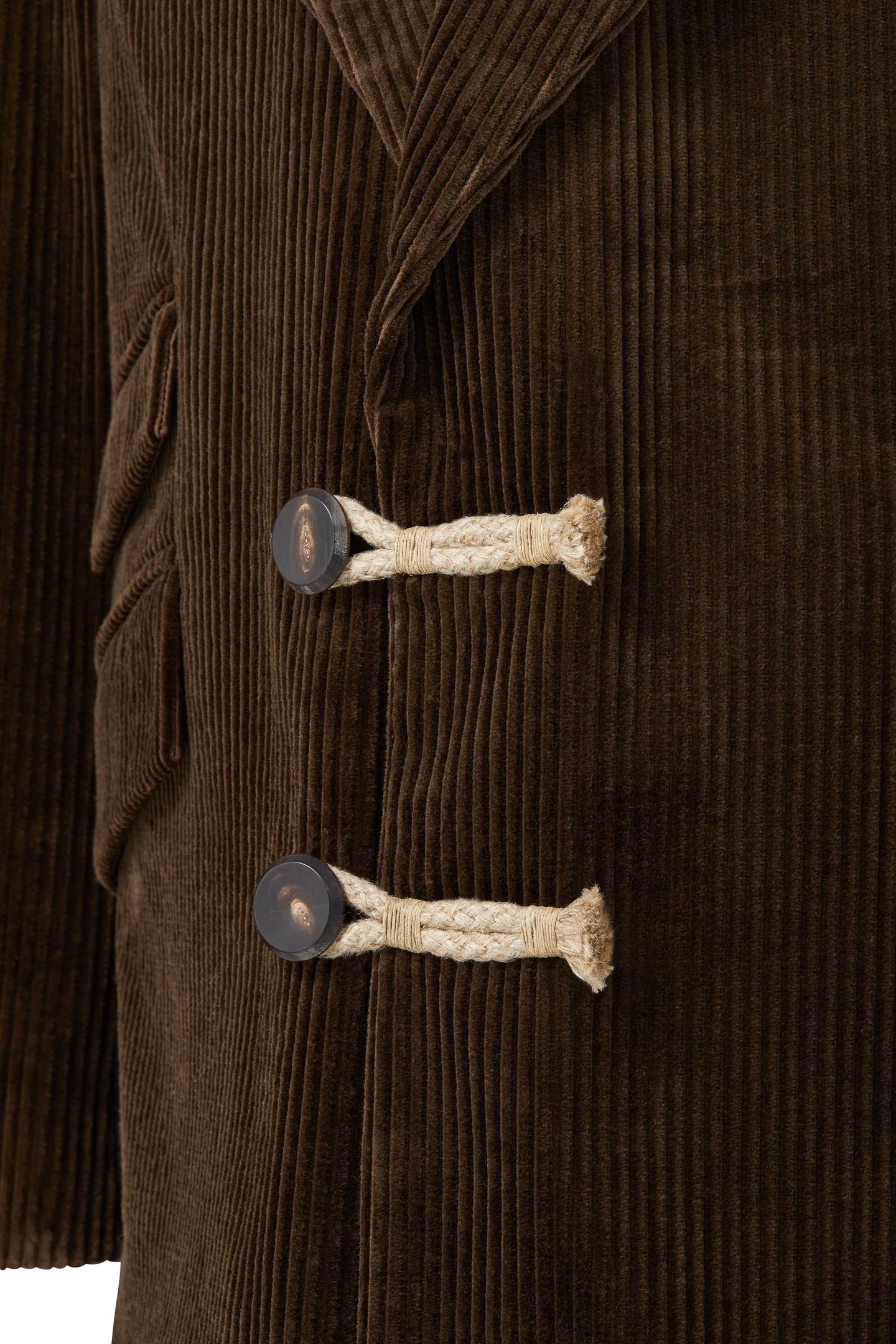 Two buttons on men's corduroy jacket brown with black and white lining made of wool and cotton
